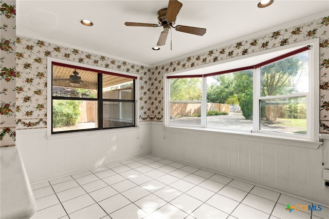 tiled spare room with crown molding, plenty of natural light, and ceiling fan