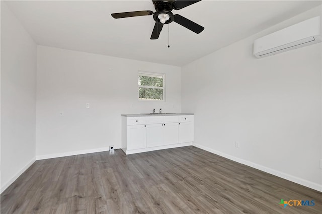 760 Lookout Dr, Canyon Lake, TX 78133 - empty room with an AC wall unit, wood finished floors, and ceiling fan