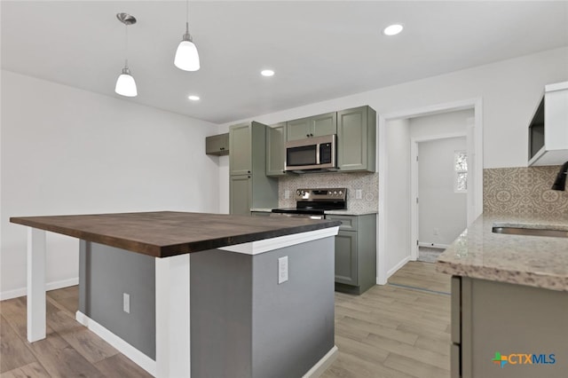760 Lookout Dr, Canyon Lake, TX 78133 - kitchen with stainless steel appliances, green cabinetry, decorative backsplash, wood counters, and recessed lighting