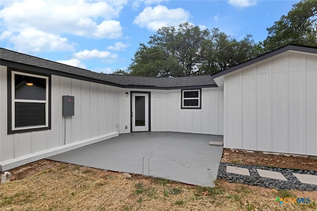 760 Lookout Dr, Canyon Lake, TX 78133 - back of house with board and batten siding, a patio, and roof with shingles