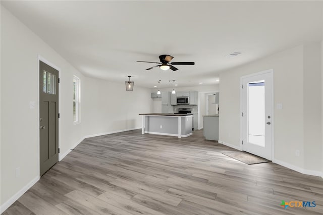 760 Lookout Dr, Canyon Lake, TX 78133 - unfurnished living room with light wood-style flooring, ceiling fan, and recessed lighting