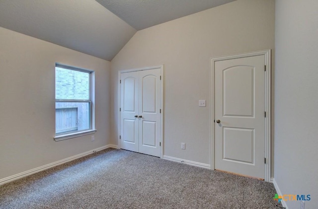 1416 Quarry Rock, New Braunfels, TX 78132 - unfurnished bedroom with lofted ceiling, carpet, baseboards, and a closet