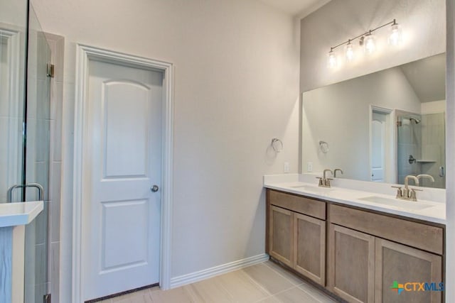 1416 Quarry Rock, New Braunfels, TX 78132 - full bathroom featuring a stall shower, tile patterned floors, double vanity, baseboards, and lofted ceiling