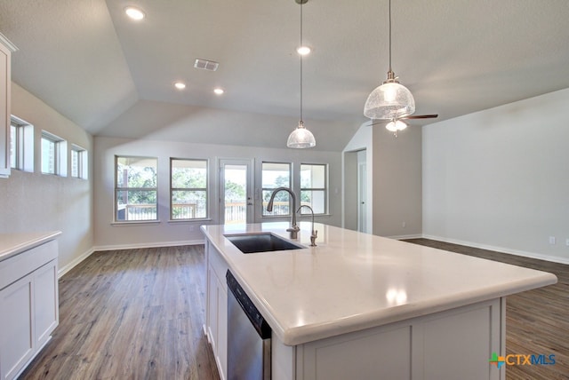 kitchen featuring pendant lighting, dishwasher, lofted ceiling, white cabinetry, and a kitchen island with sink