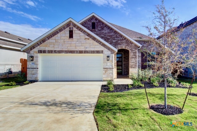 view of front of property with a garage and a front lawn