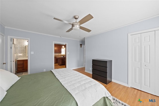 bedroom with ensuite bathroom, ornamental molding, wood finished floors, and baseboards