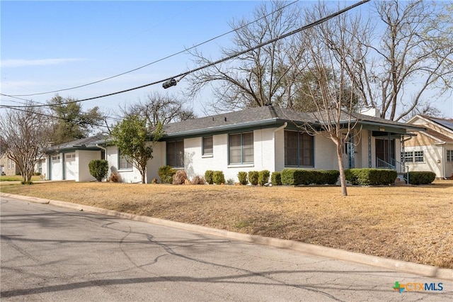 single story home with a garage and brick siding