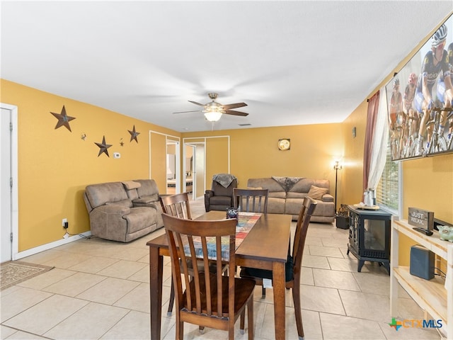 4386 Morningside Way, Canyon Lake, TX 78133 - dining space featuring a wood stove, a ceiling fan, and light tile patterned floors