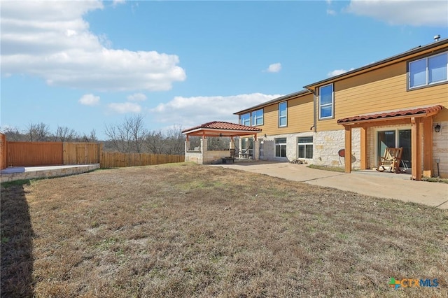 back of house with a gazebo, a lawn, and a patio area