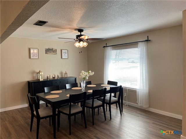 326 Riverview Rd, Mcqueeney, TX 78123 - dining room with dark wood-style flooring, a textured ceiling, a ceiling fan, and baseboards
