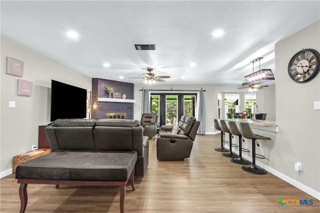 326 Riverview Rd, Mcqueeney, TX 78123 - living room with a ceiling fan, wood finished floors, recessed lighting, and a brick fireplace