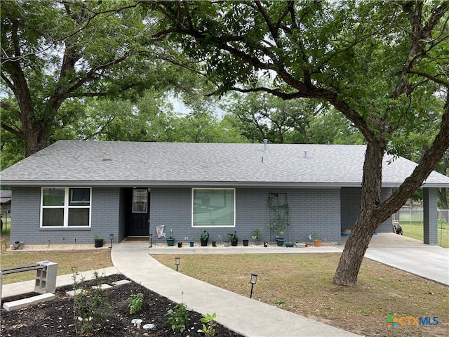 326 Riverview Rd, Mcqueeney, TX 78123 - ranch-style home with roof with shingles, brick siding, and driveway