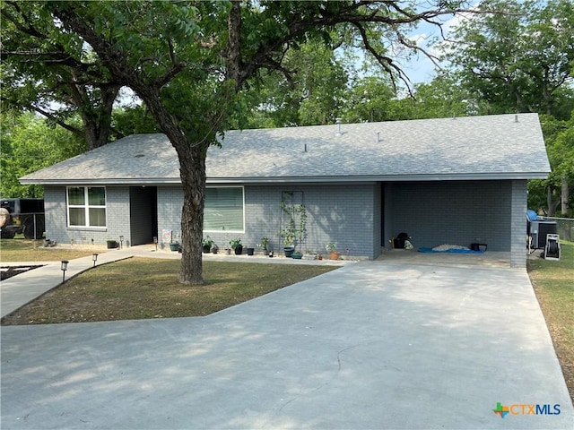 326 Riverview Rd, Mcqueeney, TX 78123 - ranch-style house with brick siding, concrete driveway, and roof with shingles