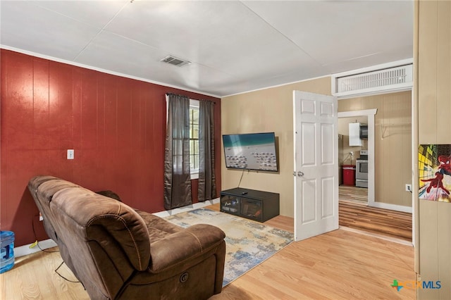 921 S Laurel Ave, Luling, TX 78648 - living room featuring wood finished floors and wooden walls