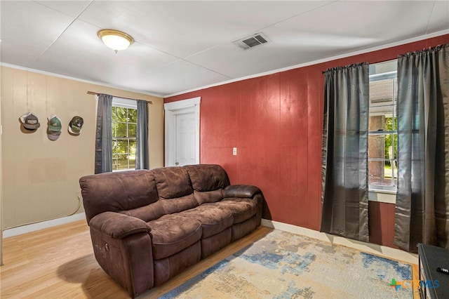 921 S Laurel Ave, Luling, TX 78648 - living room featuring wood finished floors, baseboards, crown molding, and wood walls
