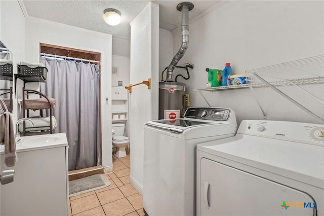 921 S Laurel Ave, Luling, TX 78648 - laundry area with water heater, washing machine and dryer, a sink, and light tile patterned floors
