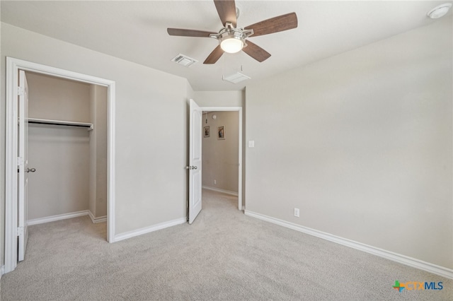 unfurnished bedroom with a closet, light carpet, and ceiling fan