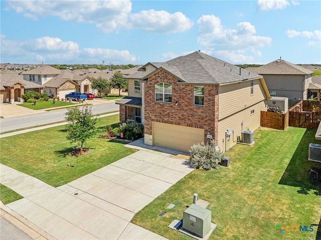 view of front of property featuring a garage, cooling unit, and a front yard