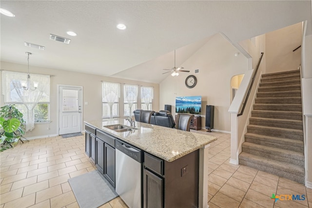 kitchen featuring light tile patterned flooring, sink, lofted ceiling, pendant lighting, and dishwasher