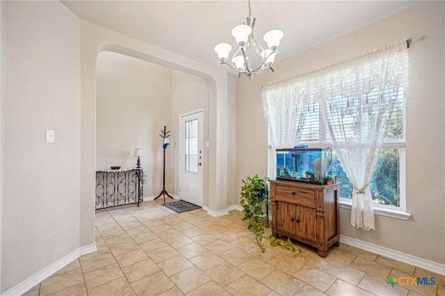 foyer entrance featuring a notable chandelier and light tile patterned flooring