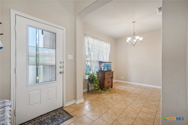 entrance foyer with a notable chandelier and light tile patterned floors