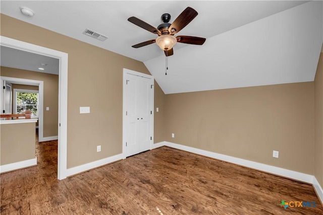 bonus room with baseboards, visible vents, a ceiling fan, lofted ceiling, and wood finished floors