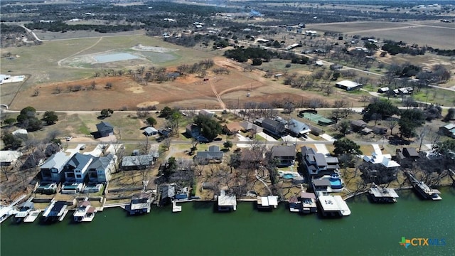 birds eye view of property featuring a water view and a residential view