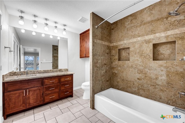 bathroom featuring visible vents, shower / bathing tub combination, toilet, vanity, and a textured ceiling