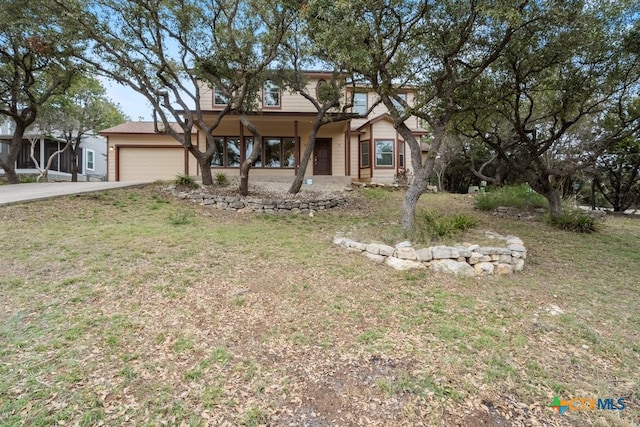 view of front of property with a front yard and a garage