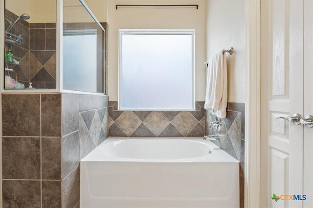 2005 Red Fox Dr, Nolanville, TX 76559 - bathroom featuring a garden tub and a tile shower