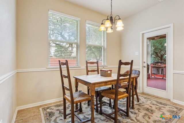 2005 Red Fox Dr, Nolanville, TX 76559 - dining space featuring a chandelier, light tile patterned floors, and baseboards