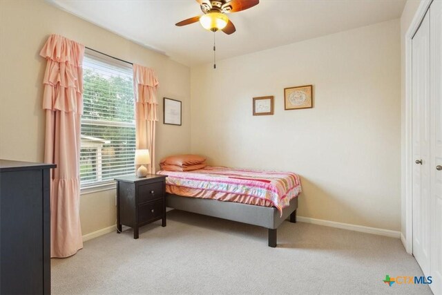 2005 Red Fox Dr, Nolanville, TX 76559 - bedroom featuring light colored carpet, a closet, baseboards, and ceiling fan