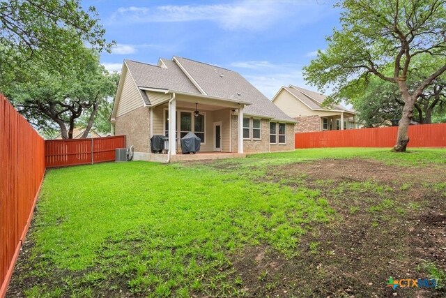 2005 Red Fox Dr, Nolanville, TX 76559 - back of house featuring central AC, a ceiling fan, and brick siding