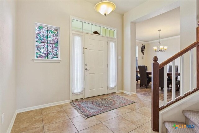 2005 Red Fox Dr, Nolanville, TX 76559 - entryway featuring stairs, a chandelier, baseboards, light tile patterned flooring, and ornamental molding