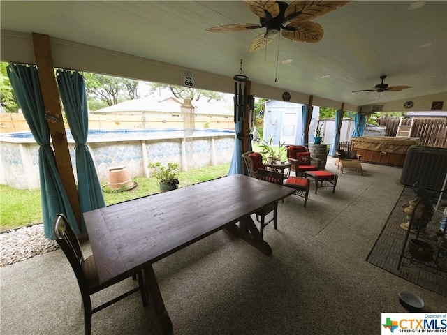 sunroom featuring ceiling fan