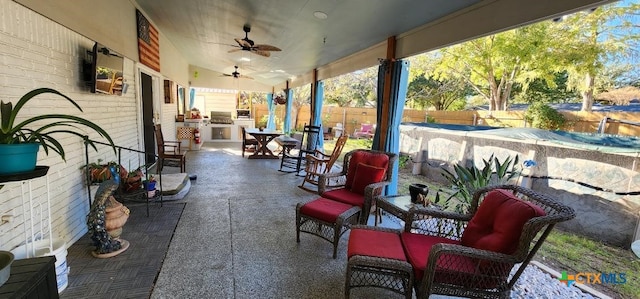 view of patio / terrace featuring ceiling fan and exterior kitchen