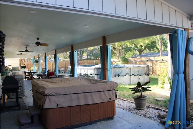 view of patio featuring a pool with hot tub and ceiling fan