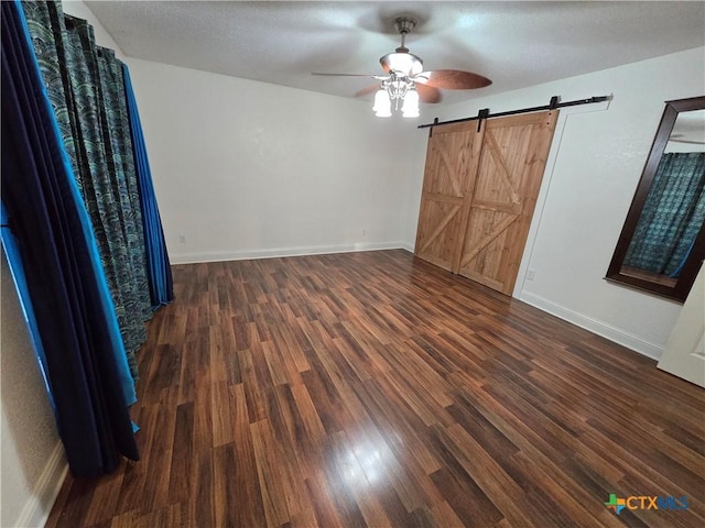 unfurnished bedroom featuring a textured ceiling, dark wood-type flooring, and ceiling fan