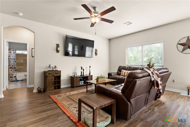 living room featuring hardwood / wood-style floors and ceiling fan