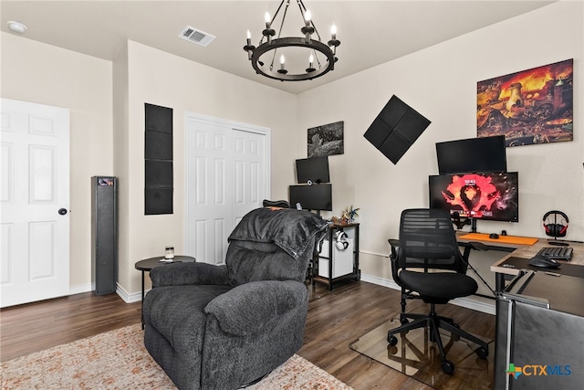 home office featuring dark hardwood / wood-style floors and an inviting chandelier