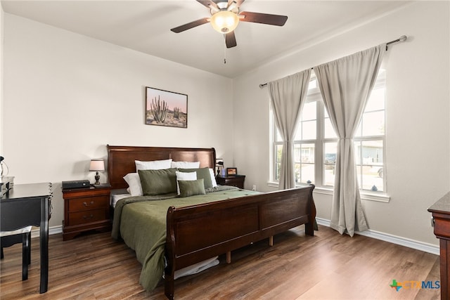 bedroom with ceiling fan and dark hardwood / wood-style floors