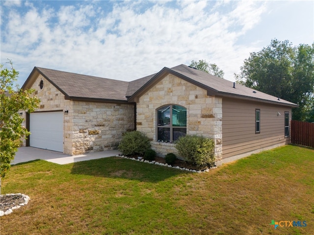 ranch-style home featuring a garage and a front lawn