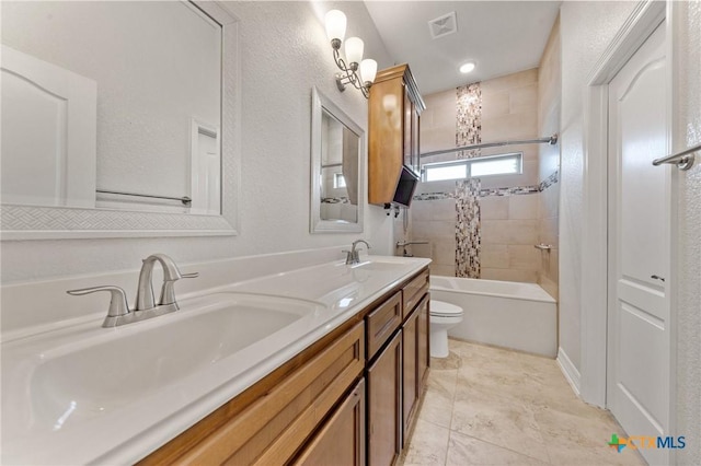 full bathroom with vanity, toilet, and tiled shower / bath