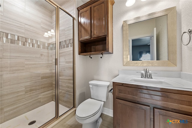 bathroom with vanity, toilet, and a shower with shower door