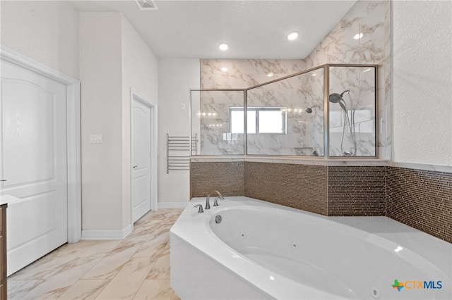 bathroom featuring separate shower and tub