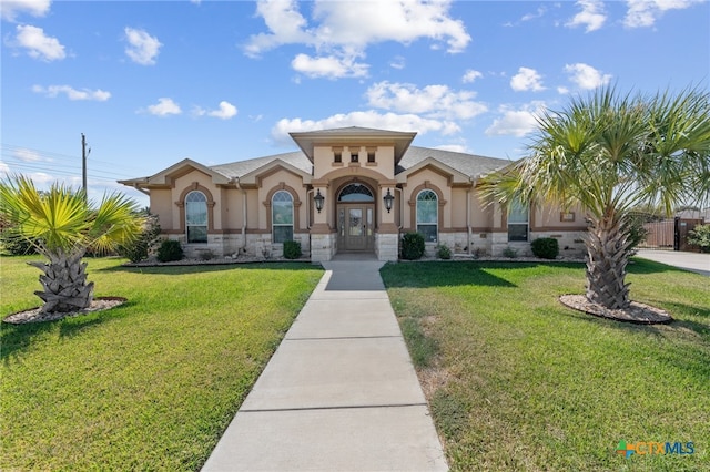 mediterranean / spanish house with a front yard