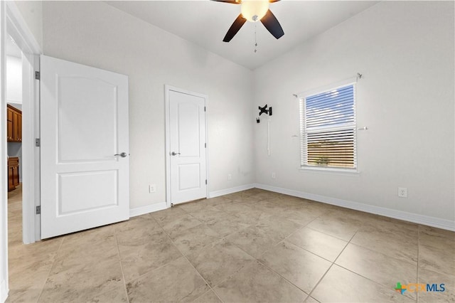 unfurnished bedroom with ceiling fan and light tile patterned floors