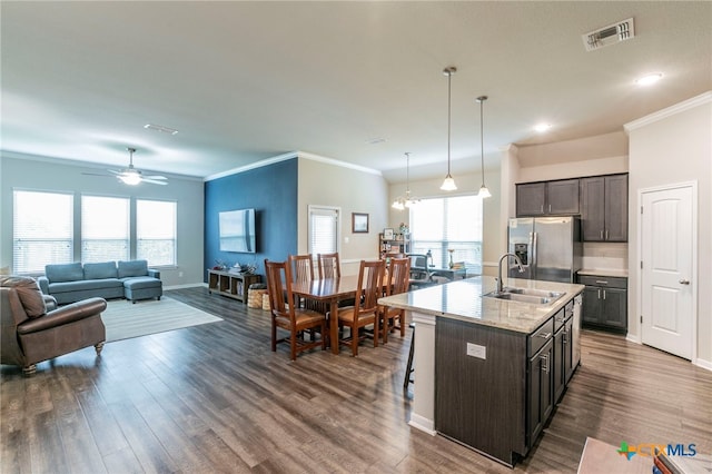 7106 Boulder Star Way, Temple, TX 76502 - kitchen with stainless steel fridge with ice dispenser, a sink, ornamental molding, dark brown cabinetry, and dark wood finished floors