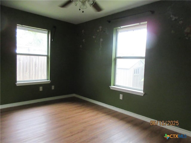 1109 E E Avenue M, Belton, TX 76513 - unfurnished room featuring plenty of natural light, a ceiling fan, and wood finished floors