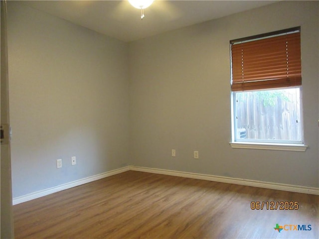 1109 E E Avenue M, Belton, TX 76513 - spare room with wood finished floors and ceiling fan